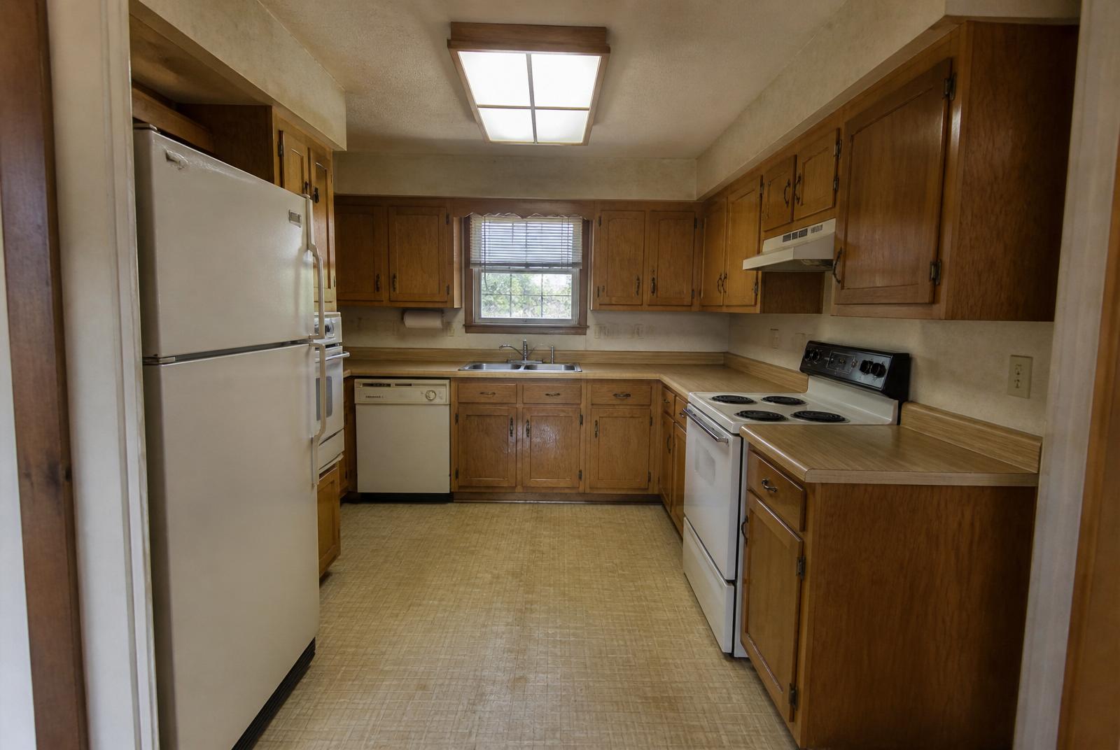 Dated kitchen before remodel in Sioux Falls, SD — oak cabinets and laminate counters